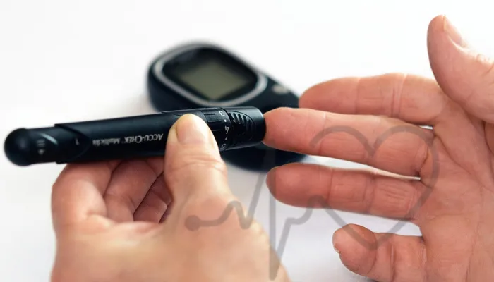Person using a glucometer to check blood sugar level with a lancet device