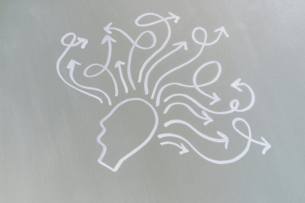 Abstract illustration of a human head with multiple arrows coming out, representing thoughts or brain activity.